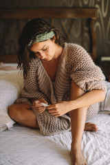 Young woman on bed looking at pregnancy test