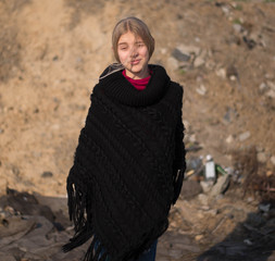 teen girl with blond hair in a hood in the desert