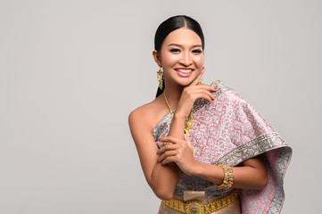Women wearing Thai clothes and hands touching their faces