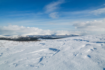Fototapeta na wymiar winter mountain landscape with blue sky and clouds