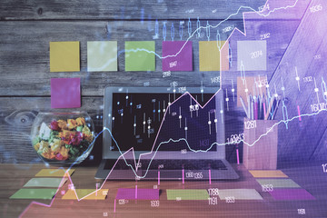 Double exposure of graph and financial info and work space with computer background. Concept of...