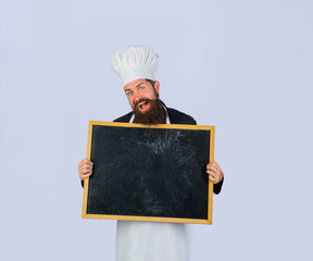 Advertisement. Empty menu chalkboard with copy space for text. Chef menu. Man cook show empty menu chalkboard with copy space. Male chef, cook or baker with blank board. Serious chef holds blackboard.