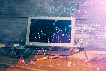 Double exposure of chart and financial info and work space with computer background. Concept of...