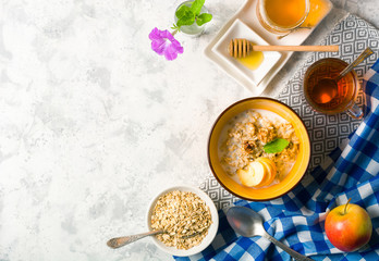 Morning oatmeal for breakfast. Early morning and healthy diet food. Proper nutrition. White stone background. Plenty of space for text.