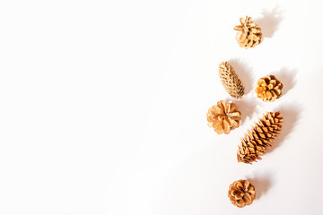 Fototapeta na wymiar Christmas pine cones on white paper border composition. Creative flat lay, top view design