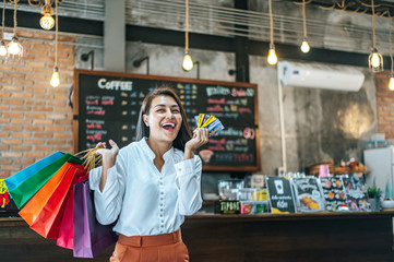 Young women enjoy shopping with credit cards.