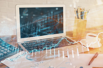 Forex market chart hologram and personal computer background. Double exposure. Concept of investment.