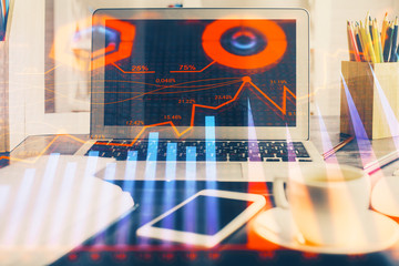 Financial market graph hologram and personal computer on background. Double exposure. Concept of forex.