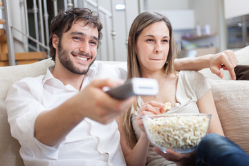 Couple eating popcorn while watching a movie