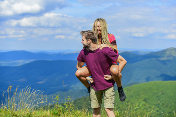 Beautiful couple embracing landscape background. Couple in love summer vacation. Love and trust. Romantic relations. Journey to mountains concept. Honeymoon in highlands. Two hearts full of love