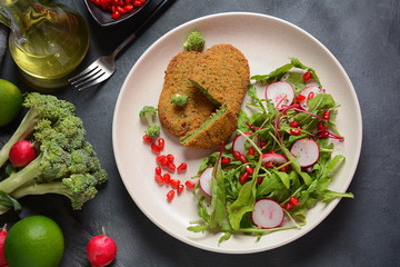 Broccoli schnitzel served with pomegranate salad. Healthy vegan food . Low -fat diet