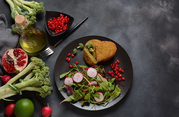 Broccoli schnitzel served with pomegranate salad. Healthy vegan food . Low -fat diet