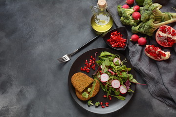 Broccoli schnitzel served with pomegranate salad. Healthy vegan food . Low -fat diet