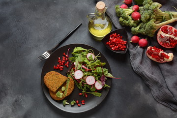 Broccoli schnitzel served with pomegranate salad. Healthy vegan food . Low -fat diet