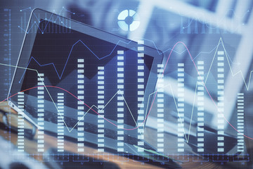 Financial graph colorful drawing and table with computer on background. Double exposure. Concept of international markets.