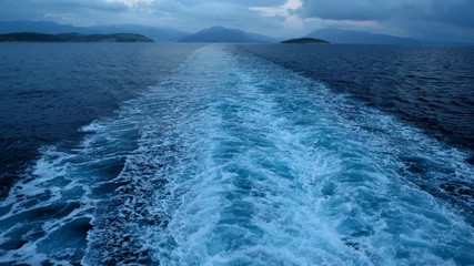 Trail on water from boat floating in Mediterranean sea. Greece. 4K