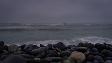 Fototapeta premium Wet stones on the seashore in Miraflores, Lima