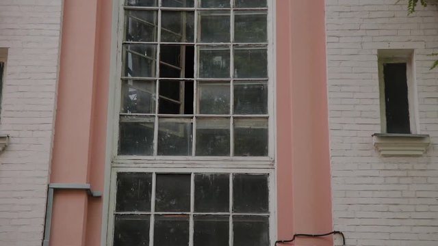 Old building with large windows in the old courtyard.