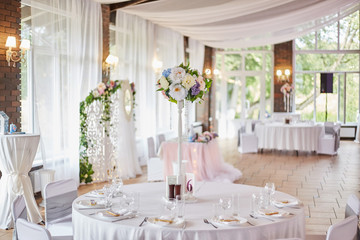 Plates with glasses on a table with a white tablecloth