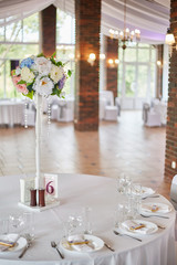 Plates with glasses on a table with a white tablecloth