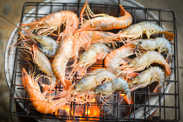 shrimp grilled bbq seafood on stove - prawns shrimps cooked burnt on grill barbecue