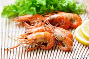 shrimp grilled bbq seafood on white plate table food - prawns shrimps cooked burnt barbecue with lemon and vegetable salad