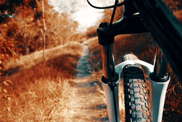 Mountain bike background. Mtb front wheel and fork close-up