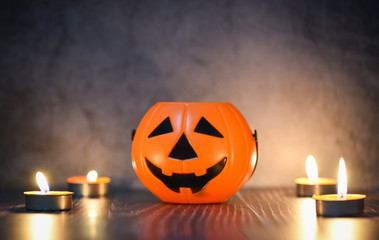 Halloween background candlelight orange decorated holidays festive concept - funny faces jack o lantern pumpkin halloween decorations for party accessories object with candle light on wood