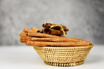 Obraz premium Cinnamon sticks on basket herbs and spices for cooked
