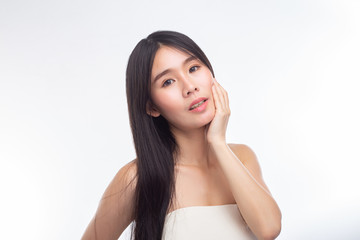 Fototapeta premium The woman wore a white strapless dress and hands touch her face.