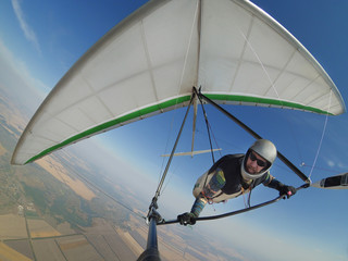 Pilot controls his hang glider wing on hign altitude.