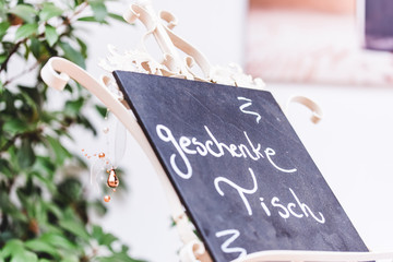 a blackboard indicating a table of presents