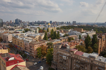 Fototapeta premium Architecture and buildings in Europe. The capital of Ukraine. Kiev city center. Street, roofs, buildings, travel, city center. Beautiful view of the city from above. Clouds over the city
