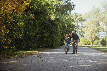 Father Learning his son to ride a bicycle	