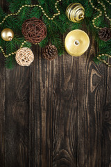 Christmas background with candle and decorations on dark wooden table.