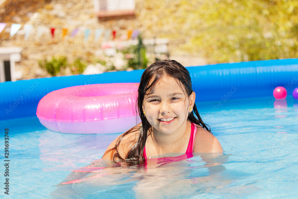 Wall mural Portrait of a girl in swimming pool