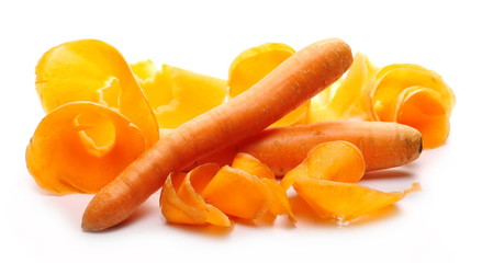Carrot with grated slices and shavings isolated on white background