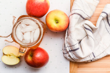 Apple juice freshly made in home kitchen with healthy chopped apples on the table