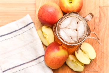 Apple juice freshly made in home kitchen with healthy chopped apples on the table
