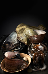 Still life with fresh mediterranean fish with place for text. The vertical orientation of the frame in the lower key.