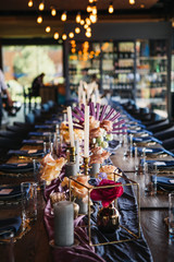 Luxury place for the amazing wedding party. Luxurious decor on the wedding table. candles, flowers, gold and blue elements