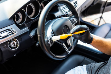 Car detailing. Cleaning the car steering wheel.