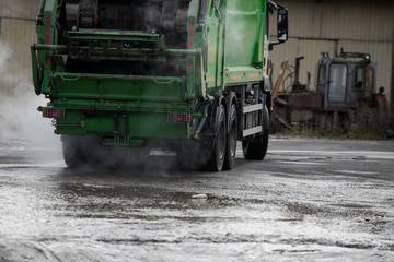 Garbage truck caught in action disposing trash.