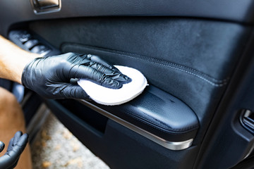 Waxing leather upholstery in the car door