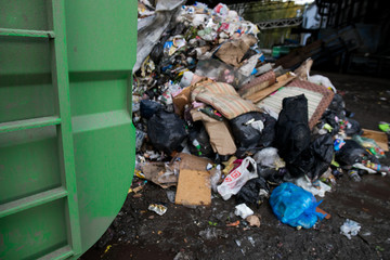 Special machinery or bulldozer work on the site of waste unloading at the plant for waste disposal. Technological process. Business for sorting and recycling.