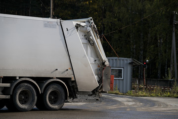 Garbage collector loading waste on the street