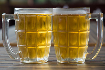 Two Mugs of Chilled Beer on a Table