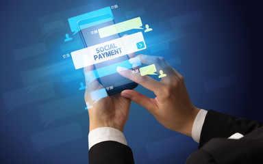 Female hand typing on smartphone with SOCIAL PAYMENT inscription, social networking concept