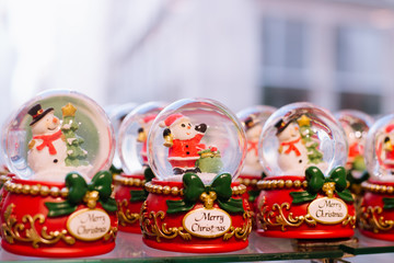 New year market. Set of holiday decorations and christmas tree toys hanging at new year trade fair shop window.