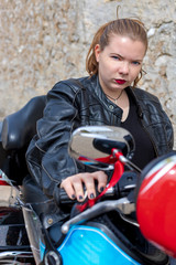 Fototapeta na wymiar bad biker girl on his motorcycle